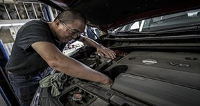 Image: man working on engine