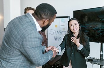 Image: two workers being introduced to each other