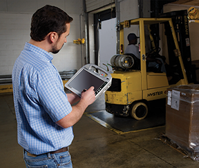 Image: maintenance supervisor working on a tablet