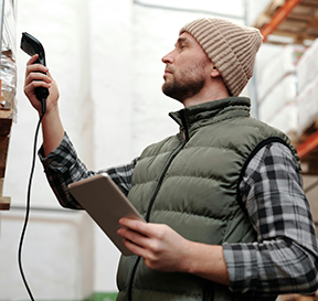 Warehouse worker scanning barcodes for inventory tracking.