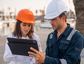 Two technicians use the variety of features of a CMMS for better maintenance.