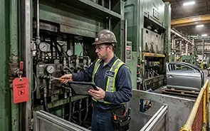 A maintenance tech finishes a work order via his mobile device.