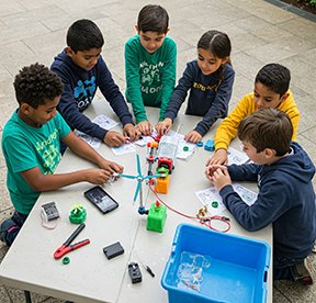 Children learning science and engineering from a STEM project.
