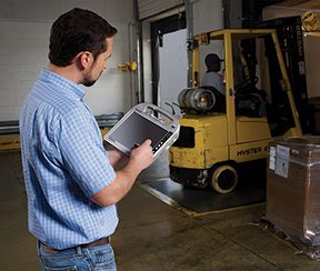 Image: maintenance supervisor working on a tablet