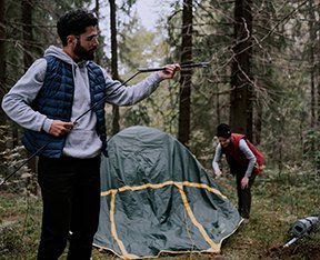 Image: couple setting up campsite