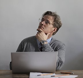 Image: man at computer wondering