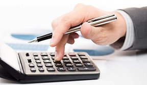 Image: hand working adding machine