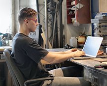 Image: man at desk on computer