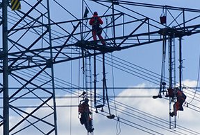 Image: men on an electrical tower