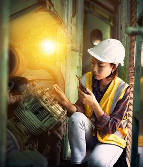 Image: woman examining a motor