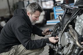 A technician conducts preventive maintenance to increase asset uptime.