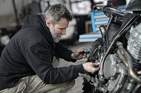 Image: man working on engine