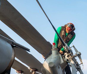 Image: maintenance men on top of machine