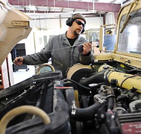 Image: man working on truck engine