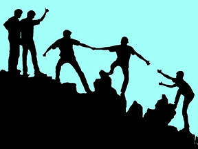 Image: silhouette of people helping others up a hill