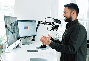 Image: man at computer videoconferencing