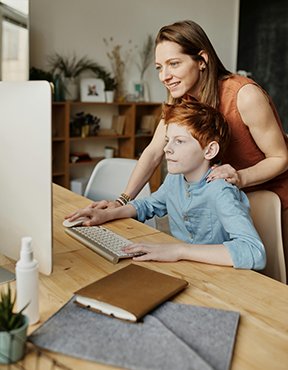 A mother teaching computer safety to her child